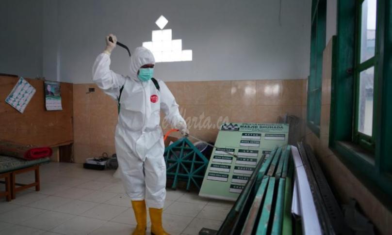Foto petugas lakukan penyemprotan desinfektan di fasilitas umum.