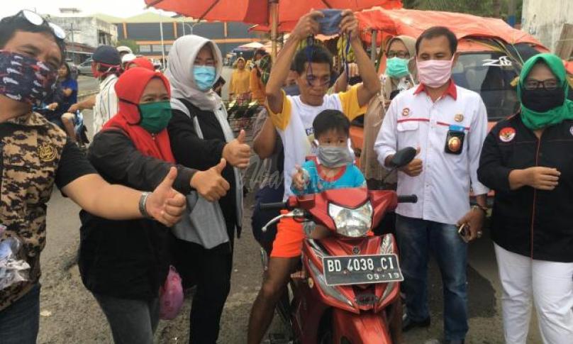 Kadinkes kota Bengkulu bersama JPKP saat membagikan masker ke para pengendara motor dan pedagang pasar tradisional.