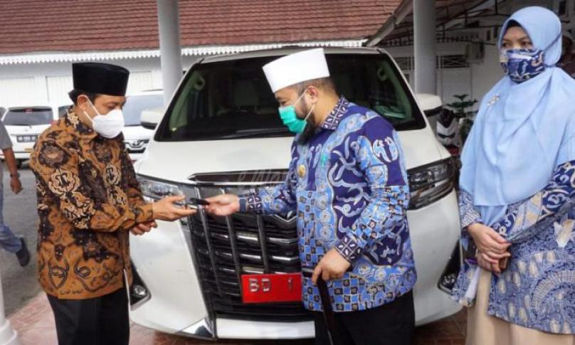 Helmi menyerahkan kunci mobil dinasnya pada wawali