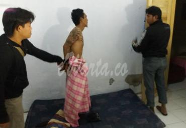 Pelaku saat ditangkap polisi di kediamanya.